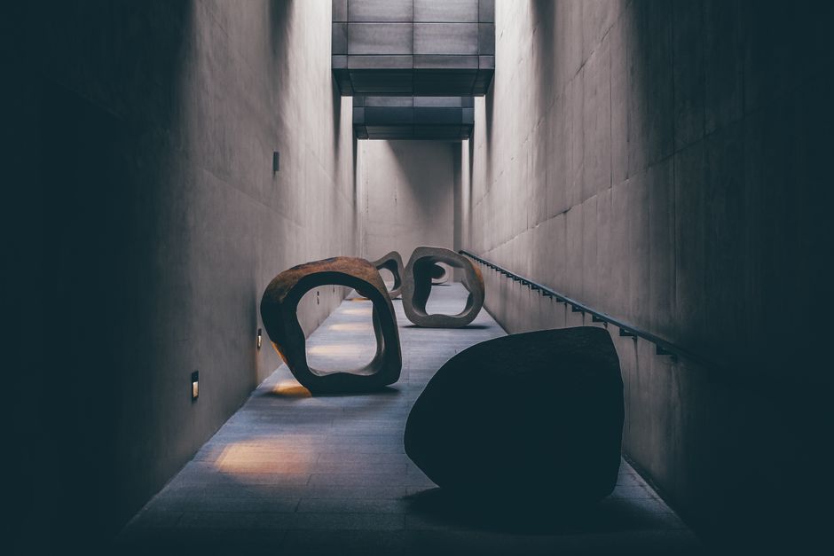 Explore a modern art sculpture installation in a dimly lit, minimalist corridor in Seoul.